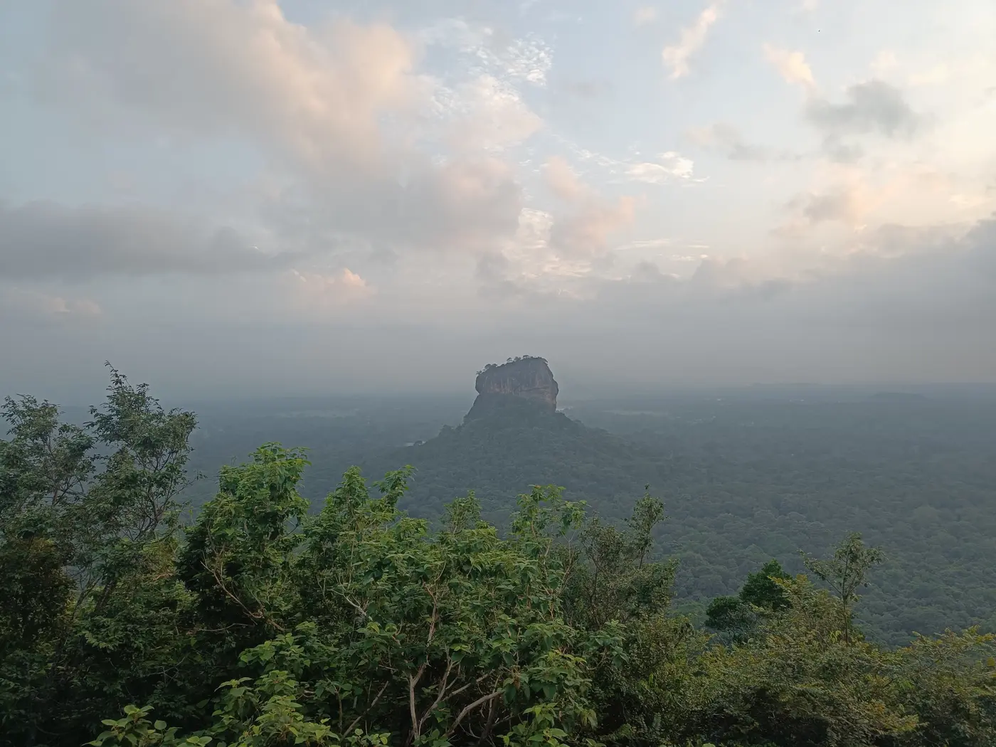 Sigiriya Rock Fortress seen across Sri Lanka's green landscape